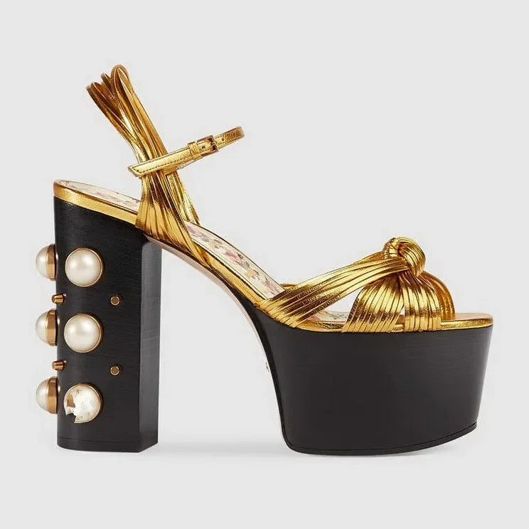 Gold metallic platform sandals with a chunky block heel and rivet detail.