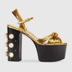 Gold metallic platform sandals with a chunky block heel and rivet detail.