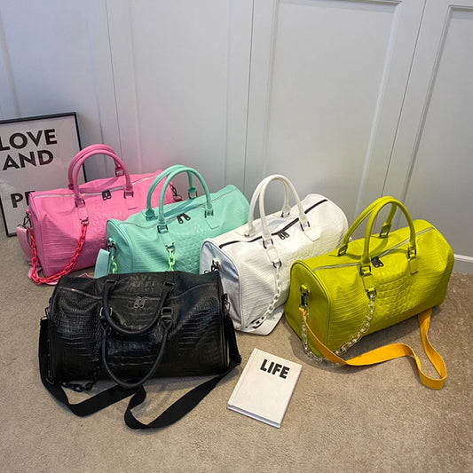 Collection of crocodile embossed travel duffle bags in various colors
