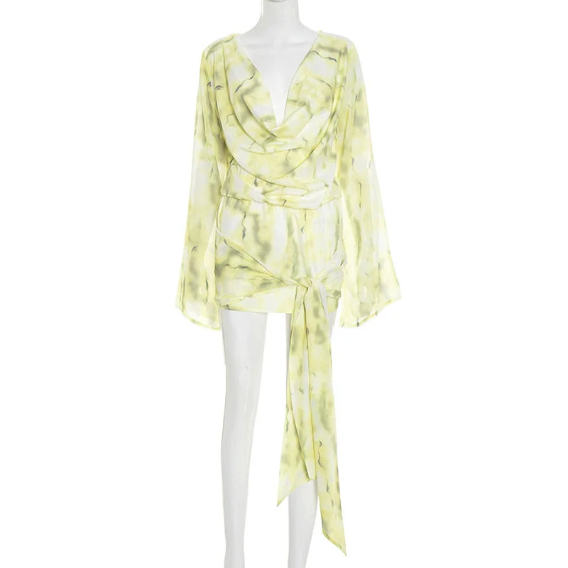 Yellow patterned dress on a mannequin against a white background