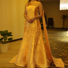  A model wearing the lilac 3D floral gown, showcasing its elegant silhouette and the daring high slit. Golden Atelier 12