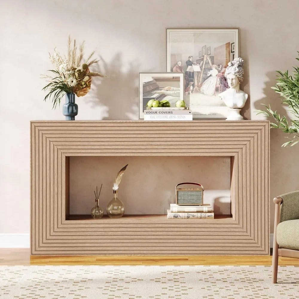 Decorative console table with framed pictures, books, and plants in a room setting.