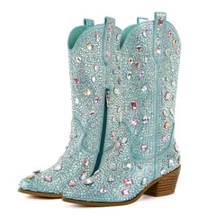 Turquoise cowboy boots with gemstone embellishments on a white background