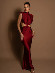 Woman wearing a red evening gown against a brown background