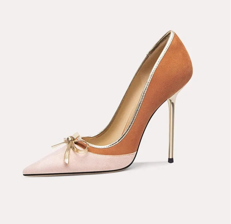 High-heeled shoe with a bow detail on a white background