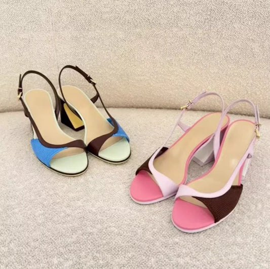 Colorblock slingback block heels on a textured sofa.