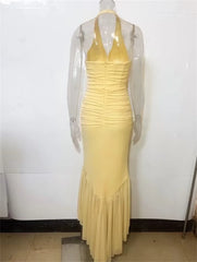 Yellow evening gown on a mannequin against a white background