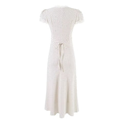 White dress with black polka dot pattern on a white background