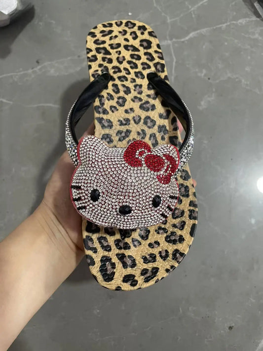 Close-up of a leopard print flip flop with a large Hello Kitty rhinestone design
