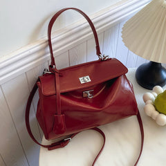 A Red leather tote bag with ample space and a structured silhouette, displayed against a clean background.