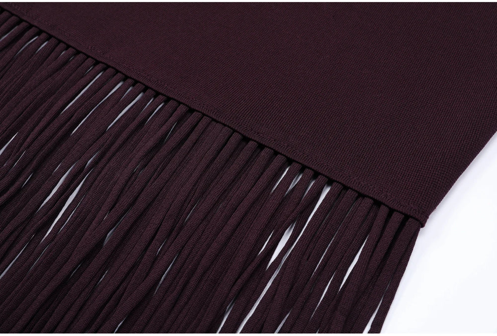Close-up of fringe hem on burgundy knitted dress
