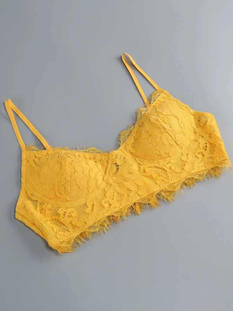 Yellow lace lingerie set on a gray background