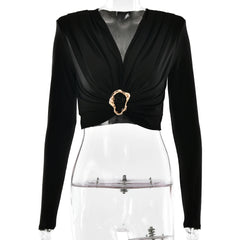 Black long-sleeve top with a decorative buckle on a mannequin against a white background
