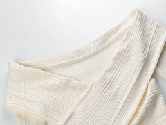 Close-up of a textured white fabric on a light gray background