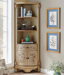Corner cabinet with decorative items and framed artwork on a wall.
