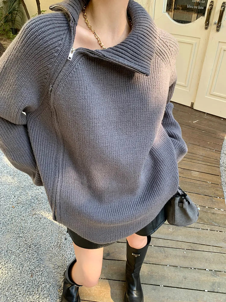 model wearing gray sweater with high-neck and a zipper
