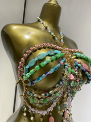 Close-up view of a multi-layer beaded body chain swimwear set detailing bead textures and colors.