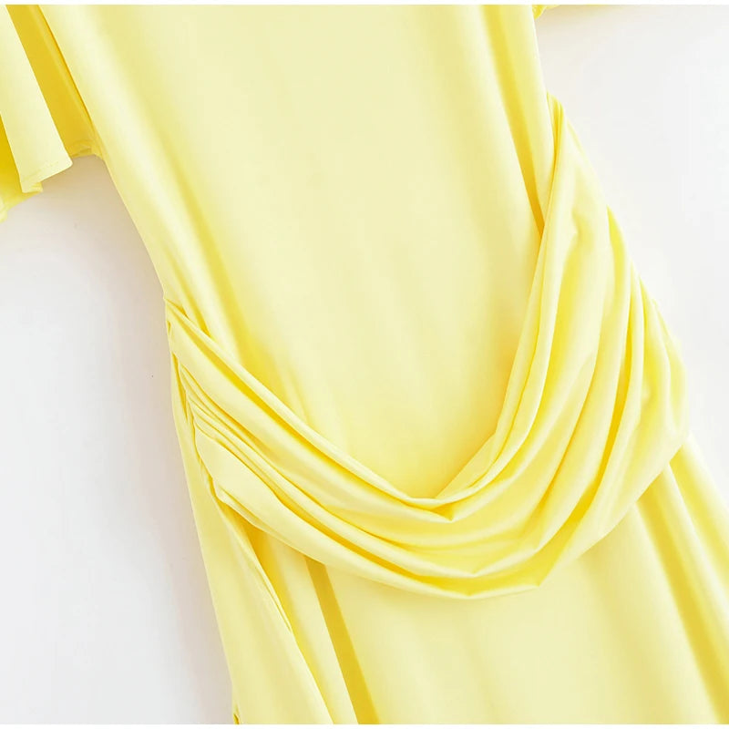 Yellow fabric draped over a white surface