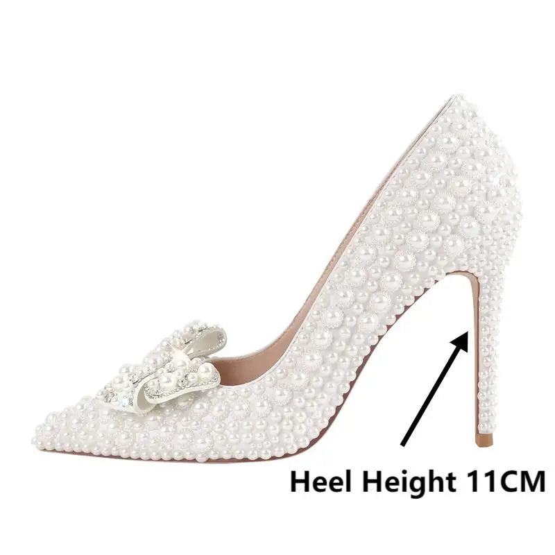 Side profile of a white stiletto heel indicating 11cm heel height, covered in pearls