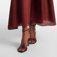 Model wearing strappy wedge heel sandals