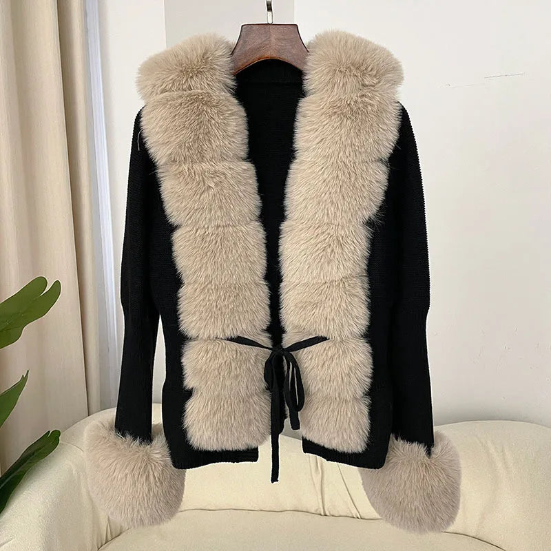 Black coat with beige fur vest on a hanger 