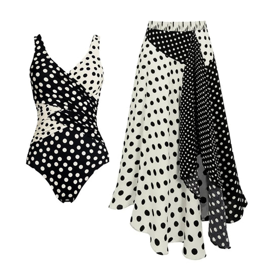 Polka dot one-piece swimwear set with wrap detail and asymmetrical skirt.