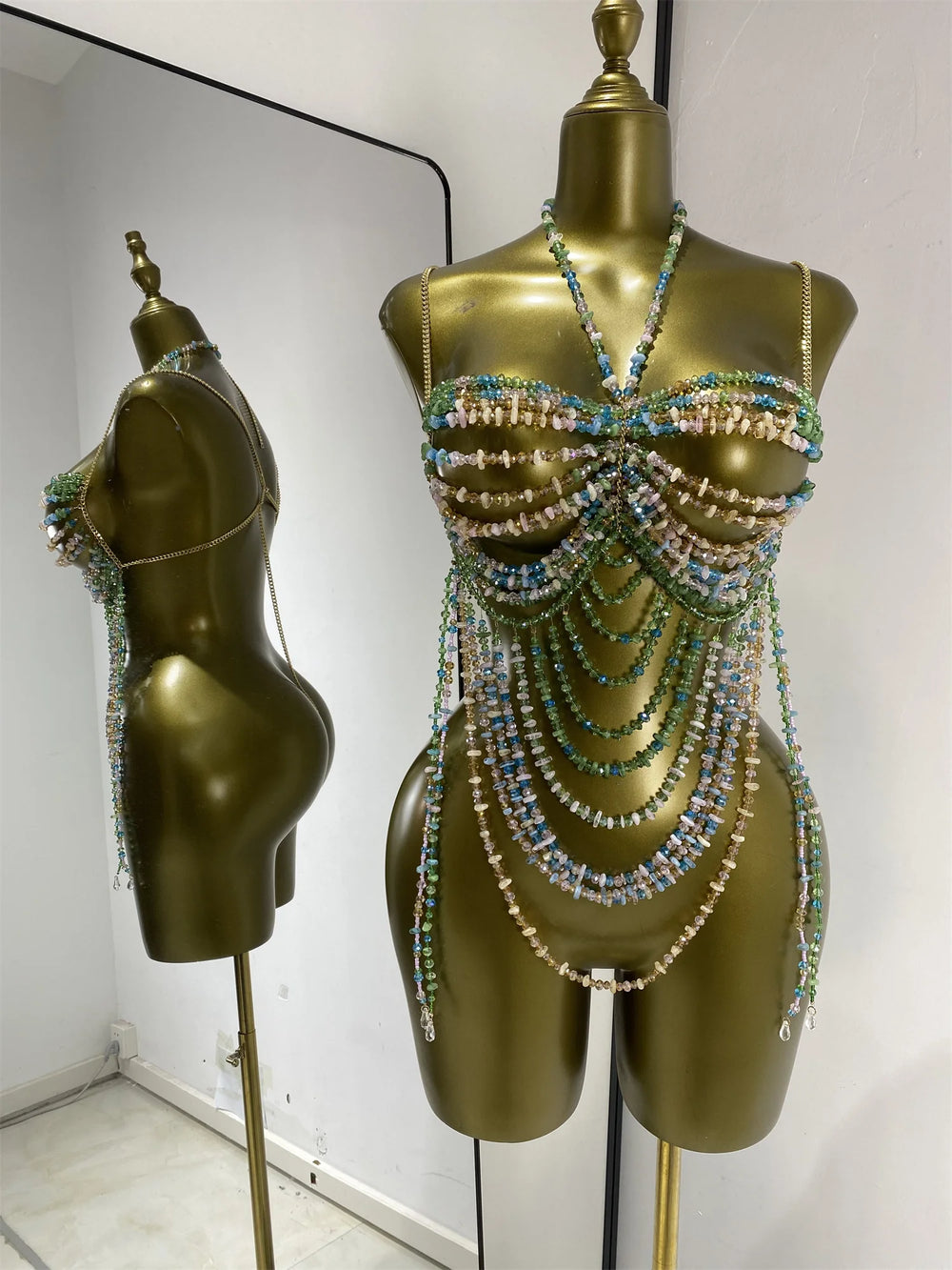 Multi-layer beaded body chain swimwear set with cascading strands in green and pastel tones.