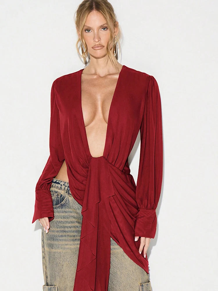 Draped plunge neck long sleeve top on model in red