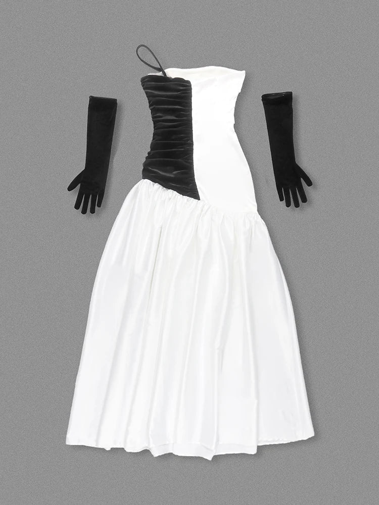 Black and white strapless dress with long black gloves on a gray background