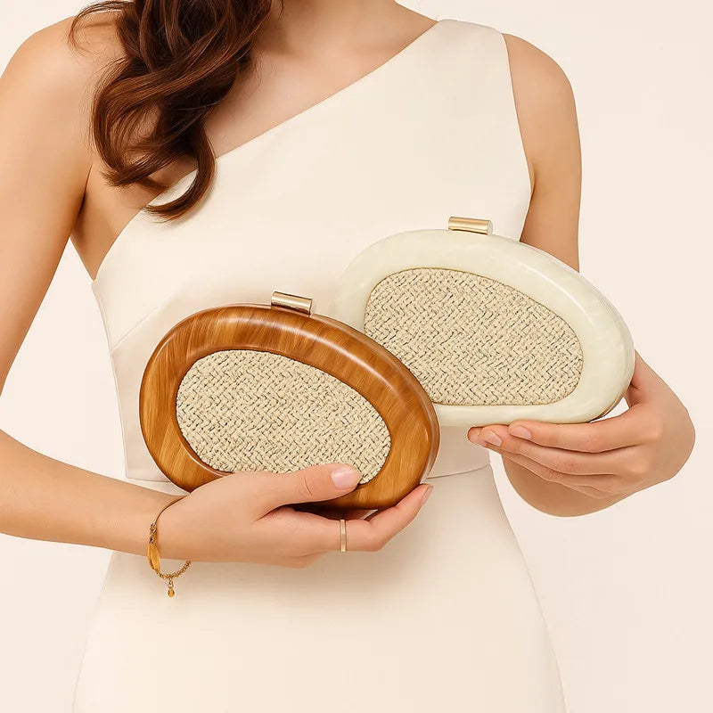 Woman holding a brown and an ivory sculptural resin clutch
