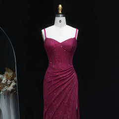Magenta evening gown on a mannequin against a black background