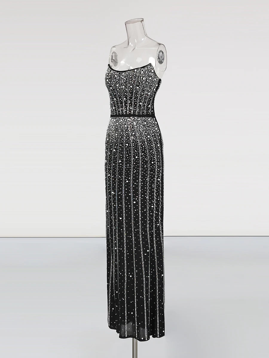 Black sequin evening gown on a mannequin against a white background