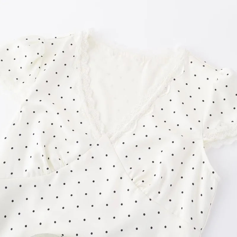 White fabric with black polka dots on a white background