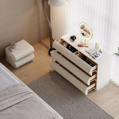 Modern bedroom with a dresser, mirror, and decor items.
