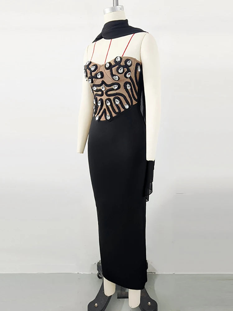 Black dress with geometric pattern on a mannequin against a white background