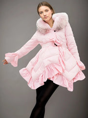 Pink quilted coat with fur trim worn by a model on a gray background