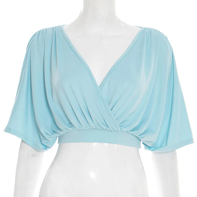 Light blue draped top on a mannequin against a white background