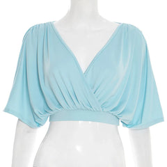 Light blue draped top on a mannequin against a white background