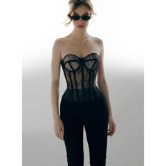 Woman wearing a black lace corset and sunglasses on a white background