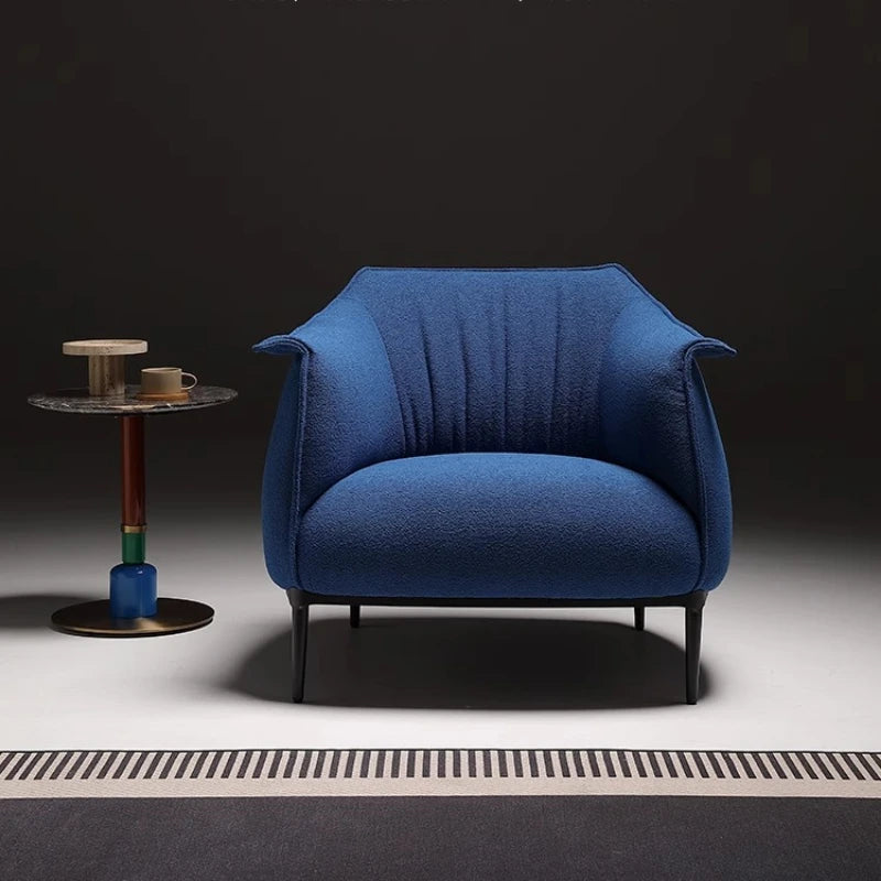 Modern blue armchair in dark minimalist setting