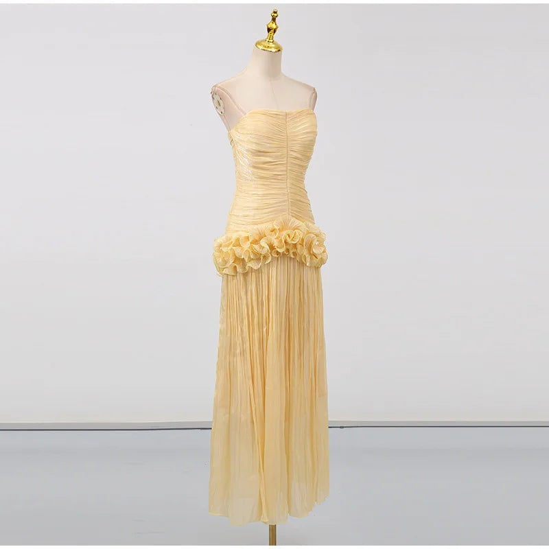 Beige strapless dress with floral details on a mannequin against a white background