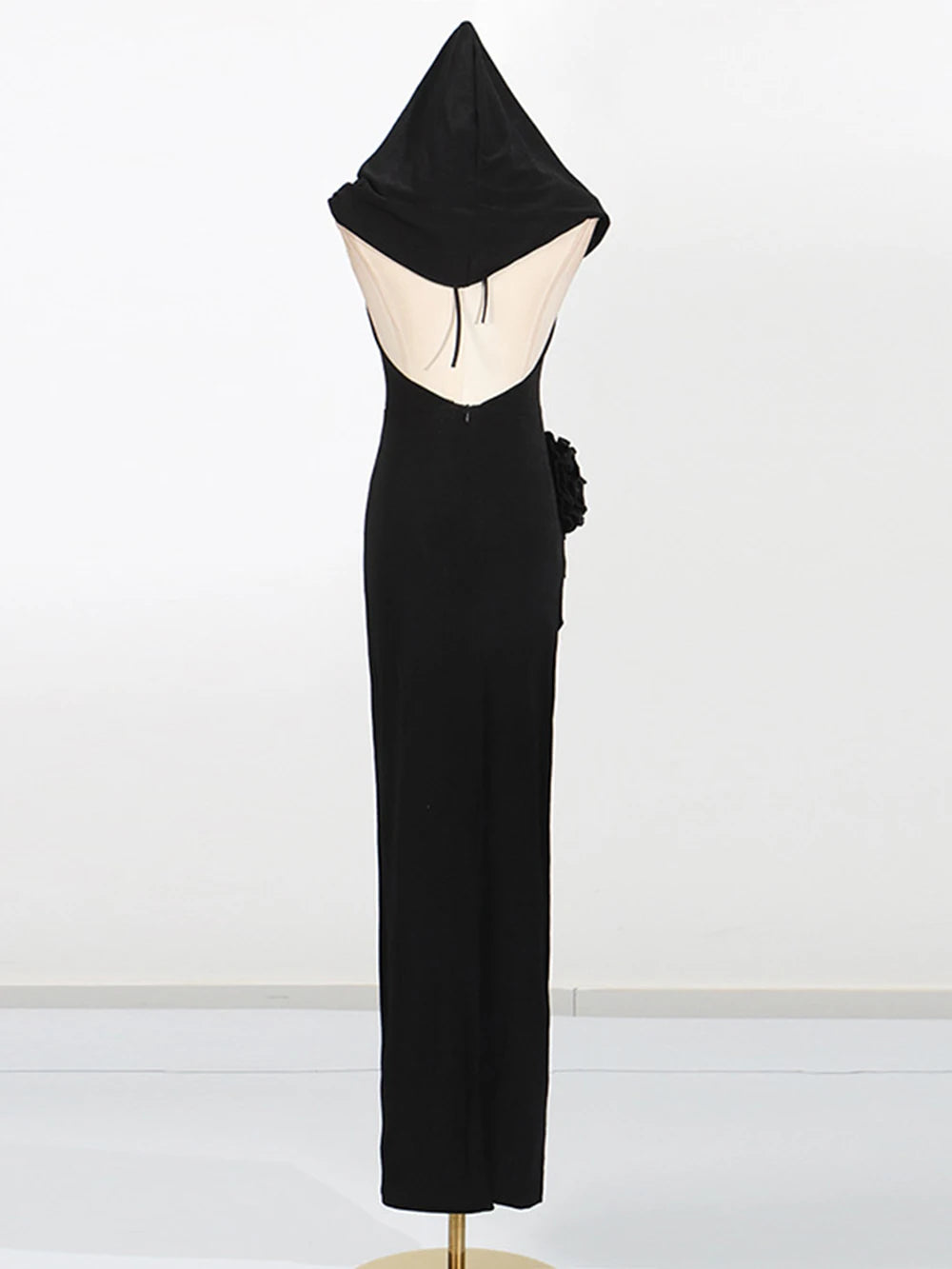 Black hooded dress on a mannequin against a white background