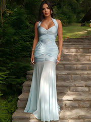 Light blue ruched halter neck maxi dress on stairs