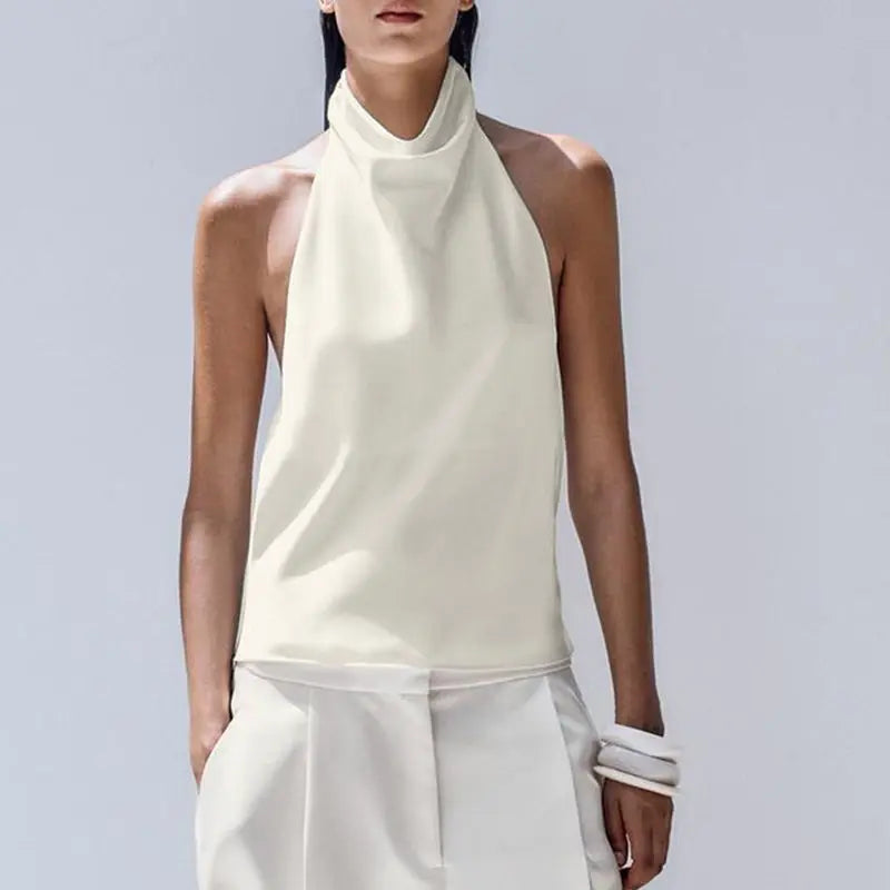 Person wearing a white sleeveless top and pants on a light gray background