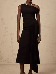 Black dress with sheer shoulder on a neutral background