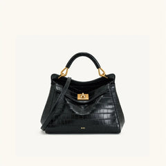Black crocodile embossed top handle bag with gold hardware.