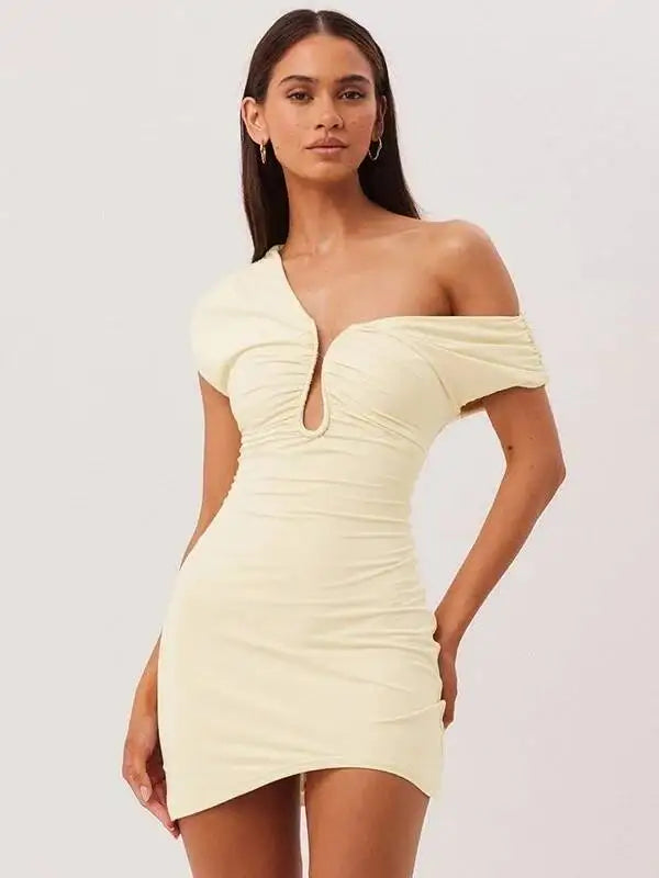 Woman wearing a light yellow off-shoulder dress on a white background