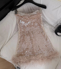 Strapless sequin mini dress with feather trim, draped on hanger