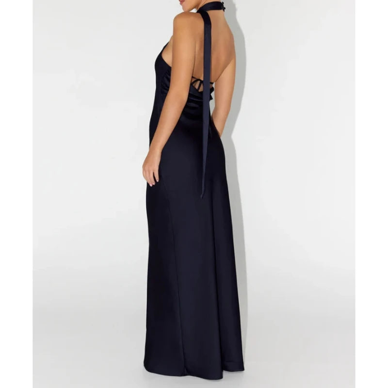 Navy blue halter neck gown on a white background