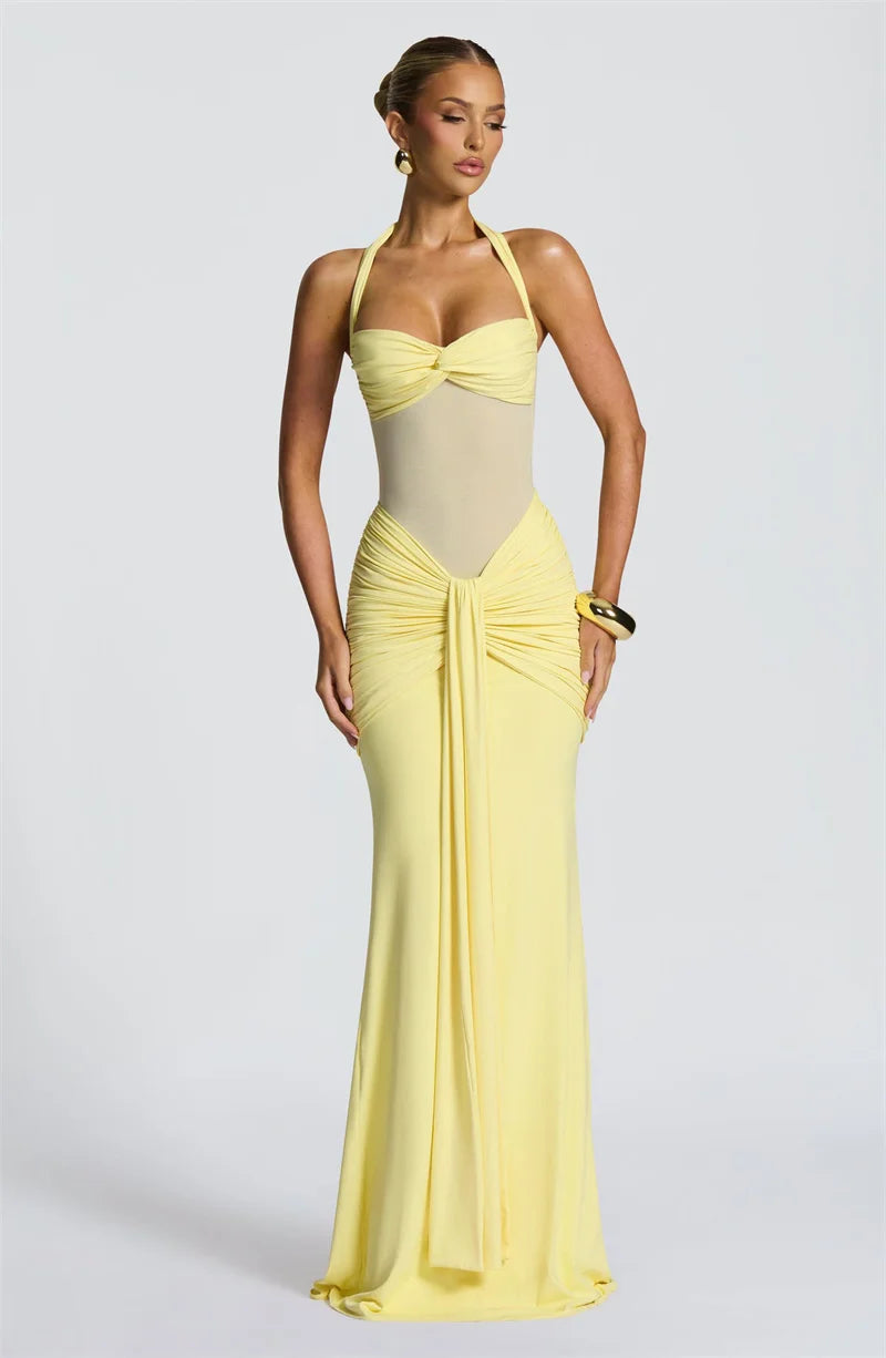 Woman wearing a yellow evening gown on a light gray background